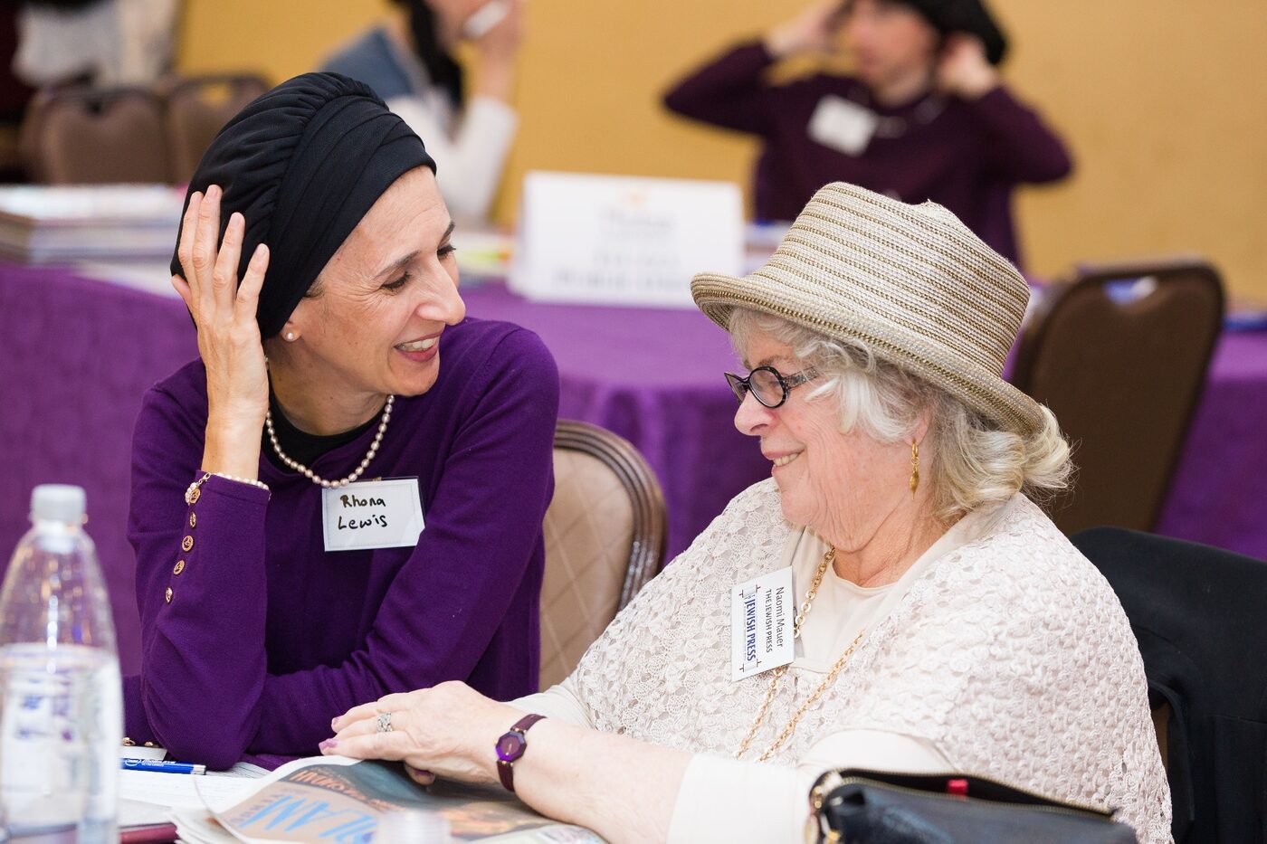 Two women writers talking closely at a JWWS gathering