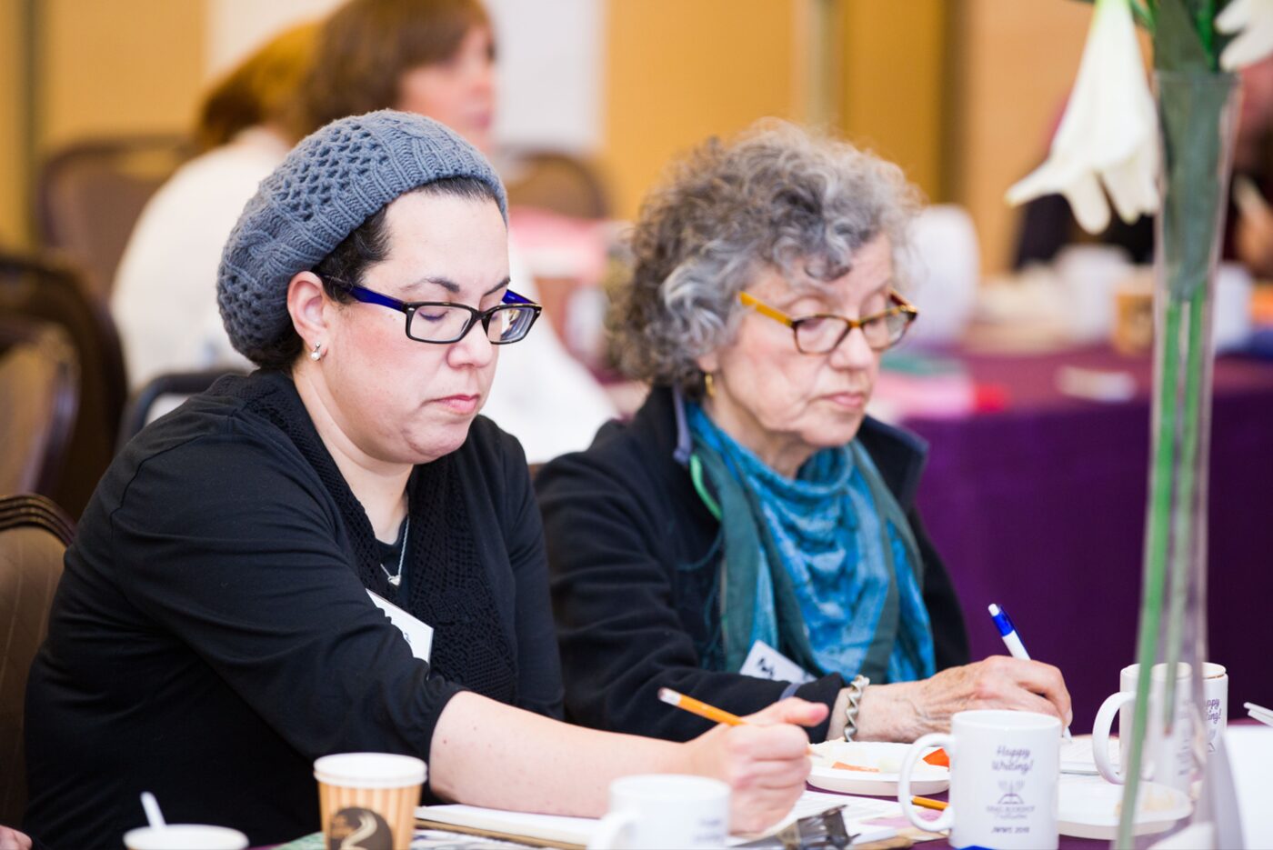 Women writing together during a JWWS Writing Room session